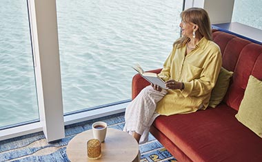 A woman reading in the Lorelei Lounge on the Spirit of the Rhine